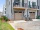 Exterior shot of home showcasing garages, small balcony, and AC units at 5003 Tiny Ln, Charlotte, NC 28203