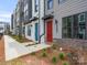 Modern townhomes feature colorful doors, brick accents, and well-manicured landscaping for a stylish curb appeal at 5003 Tiny Ln, Charlotte, NC 28203