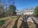 A backyard view shows the home with a gray exterior and a view of the wooden deck and yard space at 507 6Th W Ave, Gastonia, NC 28052