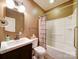 Bathroom featuring a vanity sink, toilet, and a tub-shower combo with neutral tones at 507 6Th W Ave, Gastonia, NC 28052