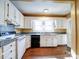 Bright kitchen features white cabinetry, black appliances, granite countertops, and a window overlooking the sink at 507 6Th W Ave, Gastonia, NC 28052