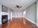 Spacious living room featuring a fireplace, ceiling fan and beautiful hardwood floors at 507 6Th W Ave, Gastonia, NC 28052