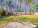 Spacious backyard featuring a concrete patio, a well-maintained lawn, and wood fencing at 5414 Peachwood Dr, Charlotte, NC 28216