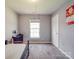 This bedroom features neutral paint, carpeted floors, a desk, and one window at 5414 Peachwood Dr, Charlotte, NC 28216