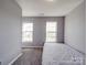 This bedroom features neutral paint, carpeted floors, and windows that provide plenty of natural light at 5414 Peachwood Dr, Charlotte, NC 28216