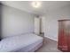 This bedroom features neutral paint, carpeted floors, and a doorway leading to another room at 5414 Peachwood Dr, Charlotte, NC 28216