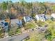 A row of houses along a tree-lined street, each featuring manicured lawns and driveways at 5414 Peachwood Dr, Charlotte, NC 28216