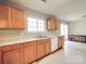 Kitchen features a double sink, white appliances, and view into dining area at 5414 Peachwood Dr, Charlotte, NC 28216