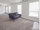 Open living space with neutral carpet and multiple windows, offers a bright and airy feel at 5414 Peachwood Dr, Charlotte, NC 28216