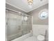 Bathroom features a bathtub with glass doors, a toilet, and an octagon window at 6141 Creft Cir, Indian Trail, NC 28079