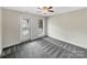 Carpeted bedroom features a ceiling fan, a window, and a balcony entrance at 6141 Creft Cir, Indian Trail, NC 28079