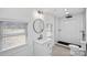 Bright bathroom featuring a modern vanity, round mirror, and walk-in shower with white subway tile at 6301 Vernedale Rd, Charlotte, NC 28212