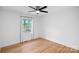 Cozy bedroom with a ceiling fan, hardwood floors, and natural light from the window at 6301 Vernedale Rd, Charlotte, NC 28212