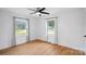 Bedroom with hardwood floors, a ceiling fan, and natural light from two windows at 6301 Vernedale Rd, Charlotte, NC 28212