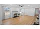 Sunlit living room with hardwood floors, a cozy fireplace, bright windows, and neutral decor at 6301 Vernedale Rd, Charlotte, NC 28212