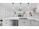 Bright kitchen flowing into the living room with a fireplace, hardwood floors, and ample natural light at 6301 Vernedale Rd, Charlotte, NC 28212