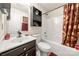 Well-maintained bathroom features a vanity, toilet, and shower/tub combination with decorative shower curtain at 6708 Burning Oak Ln, Charlotte, NC 28216