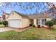 Charming single-story home with a well-maintained lawn and colorful landscaping at 6708 Burning Oak Ln, Charlotte, NC 28216