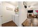 Practical laundry area includes a washer, dryer, and leads to a cozy living space with a fireplace at 6708 Burning Oak Ln, Charlotte, NC 28216