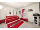 Cozy living room featuring a red leather sofa, unique mirrors, and home theater elements at 6708 Burning Oak Ln, Charlotte, NC 28216