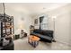 Relaxing living room featuring a black futon, dark accents, and a cozy atmosphere at 6708 Burning Oak Ln, Charlotte, NC 28216