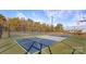 Outdoor basketball court with well-maintained green surface and a black fence at 8018 Kennesaw Dr, Gastonia, NC 28056