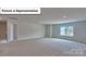 Large bonus room featuring neutral walls, plush carpeting, and a sunlit window at 8018 Kennesaw Dr, Gastonia, NC 28056