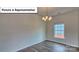 Dining room with hardwood floors, chandelier, and large window offering exterior views at 8018 Kennesaw Dr, Gastonia, NC 28056