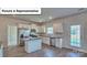 Modern kitchen with stainless steel appliances, granite countertops, and an island at 8018 Kennesaw Dr, Gastonia, NC 28056