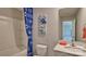 Bright bathroom with a tub/shower combination, single sink, and charming blue decor at 8073 Kennesaw Dr, Gastonia, NC 28056