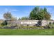 Nolen Farm entrance with stone wall, landscaping, and signage creates an inviting welcome at 8073 Kennesaw Dr, Gastonia, NC 28056