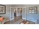 Bright living room with hardwood floors, French doors, and neutral color palette at 8073 Kennesaw Dr, Gastonia, NC 28056