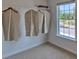 Empty walk-in closet with a single row of hanging space, carpet, and window light at 8073 Kennesaw Dr, Gastonia, NC 28056