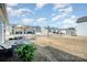 Backyard view with patio, outdoor seating, lush lawn, and surrounding homes in a neighborhood setting at 8573 River Ridge Dr, Charlotte, NC 28213