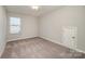 Bright bedroom with neutral walls, plush carpeting and a closet access panel at 8573 River Ridge Dr, Charlotte, NC 28213