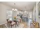 Eat-in kitchen featuring a granite-topped island, stainless steel appliances, and light-filled windows at 8573 River Ridge Dr, Charlotte, NC 28213