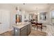 Bright kitchen features a gray island with granite countertop and stainless steel appliances at 8573 River Ridge Dr, Charlotte, NC 28213