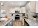 Contemporary kitchen with granite countertops, stainless steel appliances, and ample natural light at 8573 River Ridge Dr, Charlotte, NC 28213