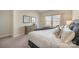 Stylish main bedroom includes a window, artwork, and neutral finishes at 8573 River Ridge Dr, Charlotte, NC 28213