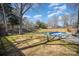 Spacious backyard featuring a gunite pool, lush green grass, and a wooden fence at 9200 Four Acre Ct, Charlotte, NC 28210