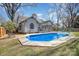 Home exterior featuring a pool, screened-in porch, and well-manicured yard at 9200 Four Acre Ct, Charlotte, NC 28210