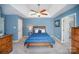 Comfortable bedroom with a ceiling fan, neutral carpet, and blue accent walls is perfect for a restful retreat at 9200 Four Acre Ct, Charlotte, NC 28210