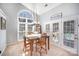 Bright dining area with a statement window, stylish lighting, and access to the outdoor space at 9200 Four Acre Ct, Charlotte, NC 28210