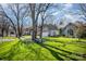 Beautifully landscaped front yard with mature trees that complements the exterior of the house at 9200 Four Acre Ct, Charlotte, NC 28210