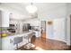 Bright kitchen featuring white cabinets, granite countertops, stainless steel appliances, and a breakfast bar with seating at 9200 Four Acre Ct, Charlotte, NC 28210