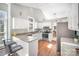 Well-lit kitchen showcasing white cabinetry, granite countertops, stainless steel appliances, and a breakfast bar with seating at 9200 Four Acre Ct, Charlotte, NC 28210