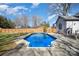 Outdoor pool featuring clear blue water, concrete surround, and a wooden fence at 9200 Four Acre Ct, Charlotte, NC 28210