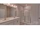 Modern bathroom features a double sink vanity and glass-enclosed shower at 9534 Maltese Dr, Gastonia, NC 28056