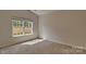 Bedroom with neutral carpet and a large window overlooking the backyard at 9534 Maltese Dr, Gastonia, NC 28056