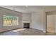 Living room with a cozy fireplace and natural light from the large window at 9534 Maltese Dr, Gastonia, NC 28056